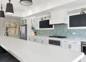 Thumbnail 30 of 30 - a large kitchen with white cabinets and a white counter top at Park 205, Park Ridge, IL