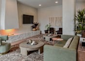 Thumbnail 44 of 83 - A living room with a green couch and a coffee table.