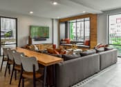 Thumbnail 25 of 42 - a living room with a couch and a table with chairs at The View on Collins, Lansing, 48910
