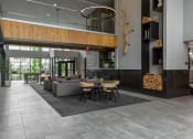 Thumbnail 20 of 42 - the lobby of a building with couches and tables and chairs at The View on Collins, Lansing, Michigan