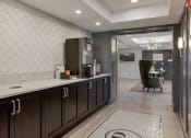 Thumbnail 26 of 30 - a kitchen with dark wood cabinets and a white counter top at Park 205, Illinois