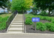 Thumbnail 19 of 30 - a dog park sign in front of a set of stairs