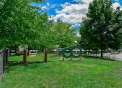 Thumbnail 20 of 30 - a park with trees and a sculpture in the grass