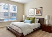 Thumbnail 7 of 22 - Westerville, OH Apartments Near Target - Kenyon Square - Furnished Bedroom with Plush Carpet Flooring, 9’ Ceiling, and an Oversized Window with Blinds