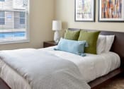 Thumbnail 8 of 22 - a bedroom with a large bed with green and white pillows