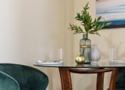 Thumbnail 12 of 22 - a table with green chairs and a vase with flowers on it