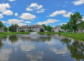 Thumbnail 30 of 30 - a pond in front of a house with a fountain