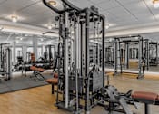 Thumbnail 51 of 83 - A gym with a variety of equipment including a leg press machine.
