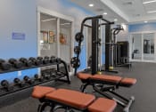 Thumbnail 17 of 79 - a gym with weights and other exercise equipment in a building at The Commons at Rivertown, Grandville, MI, 49418