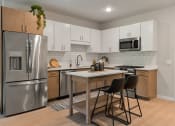 Thumbnail 2 of 62 - Kitchen with White Cabinets at The Aurilla, Cottage Grove, Minnesota