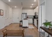 Thumbnail 5 of 42 - an open kitchen and living room with a dining room table and at The View on Collins, Lansing, Michigan