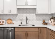 Thumbnail 3 of 62 - Kitchen with White Backsplash at The Aurilla, Cottage Grove, Minnesota