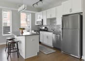Thumbnail 1 of 30 - a kitchen with white cabinets and a stainless steel refrigerator at Park 205, Park Ridge, Illinois