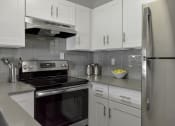 Thumbnail 2 of 30 - a kitchen with stainless steel appliances and white cabinets