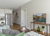 Thumbnail 4 of 30 - a living room with a couch and a table with a television at Park 205, Park Ridge, 60068