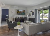Thumbnail 4 of 30 - a living room with a couch and chairs and a fireplace