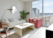 Thumbnail 6 of 57 - a living room with a white couch and a chair and a large window