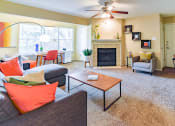 Thumbnail 17 of 43 - a living room with a fireplace and a ceiling fan  at Riverset Apartments, Tennessee