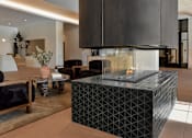 Thumbnail 37 of 83 - A modern living room with a black and white geometric coffee table.
