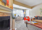 Thumbnail 26 of 43 - a living room with a fireplace and a large window  at Riverset Apartments, Memphis