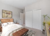 Thumbnail 22 of 62 - a bedroom with white walls and a bed with a wooden headboard at The Aurilla, Minnesota, 55016