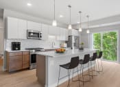 Thumbnail 14 of 62 - Kitchen with White Cabinets at The Aurilla, Cottage Grove, Minnesota