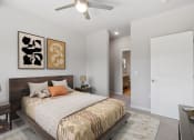Thumbnail 19 of 62 - a bedroom with a bed and a ceiling fan at The Aurilla, Cottage Grove, MN, 55016