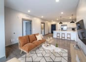 Thumbnail 49 of 79 - Living Room & Kitchen in Open Concept Layout at The Commons at Rivertown, Grandville, MI