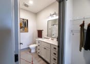 Thumbnail 57 of 79 - a bathroom with a sink and a toilet and a mirror at The Commons at Rivertown, Grandville, MI, 49418