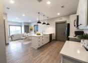 Thumbnail 74 of 79 - Open kitchen that overlooks dining and living area at The Commons at Rivertown, Grandville, 49418