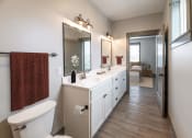 Thumbnail 69 of 79 - a bathroom with a large mirror and a toilet at The Commons at Rivertown, Grandville