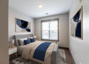 Thumbnail 71 of 79 - a bedroom with a large bed at The Commons at Rivertown, Grandville