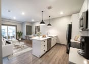 Thumbnail 31 of 79 - a kitchen and living room in an apartment at The Commons at Rivertown, Grandville, 49418