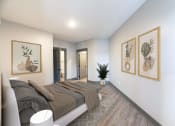 Thumbnail 38 of 79 - a bedroom with a bed and two paintings on the wall at The Commons at Rivertown, Grandville, MI, 49418