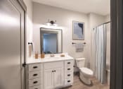 Thumbnail 41 of 79 - a bathroom with a sink and a toilet and a shower at The Commons at Rivertown, Grandville, MI