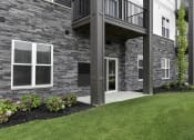 Thumbnail 9 of 79 - a view of the front of a house with a porch and a balcony at The Commons at Rivertown, Grandville, 49418