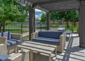 Thumbnail 17 of 30 - a patio with couches and chairs and a pergola
