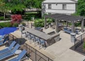 Thumbnail 25 of 30 - a patio with lounge chairs and tables and a fire pit