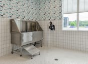 Thumbnail 26 of 79 - a large stainless steel tub in a bathroom with a window at The Commons at Rivertown, Grandville, MI