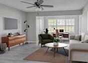 Thumbnail 4 of 43 - A living room with a green chair and a brown rug.