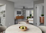 Thumbnail 3 of 43 - A modern kitchen with a dining table and chairs.