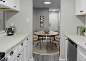Thumbnail 2 of 43 - A kitchen with a table and chairs in the middle.