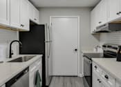 Thumbnail 1 of 43 - A kitchen with black and white appliances and cabinets.