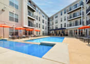 Thumbnail 2 of 22 - Westerville, OH Apartments Near Top Golf - Kenyon Square - Swimming Pool with Orange Umbrellas and Lounge Chairs