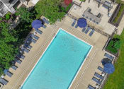 Thumbnail 22 of 30 - a swimming pool with umbrellas and chairs around it