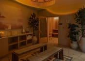 Thumbnail 58 of 83 - A living room with a couch, a table, and a potted plant.