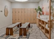 Thumbnail 56 of 83 - A room with wooden benches and lockers.