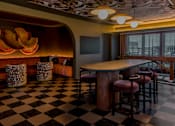Thumbnail 62 of 83 - A black and white checkered floor in a room with a bar.