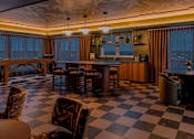 Thumbnail 61 of 83 - A black and white checkered floor in a room with a bar.
