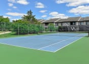 Thumbnail 29 of 30 - a blue and green tennis court with a house in the background
